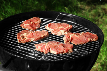 Raw steak on grill outdoors