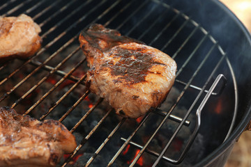 Tasty steaks on barbecue grill, close up