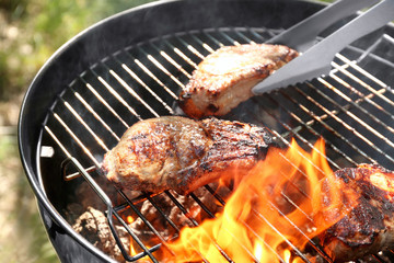 Tasty steaks on barbecue grill, close up - obrazy, fototapety, plakaty