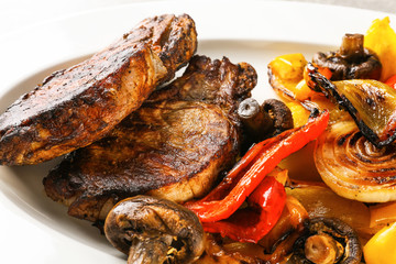 Plate with tasty grilled steaks and vegetables, close up