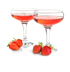 Glasses of delicious strawberry wine on white background