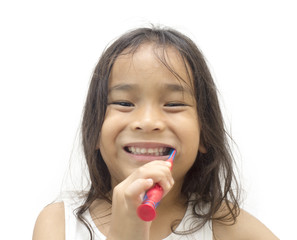 Smiling child kid brushing teeth in bathroom