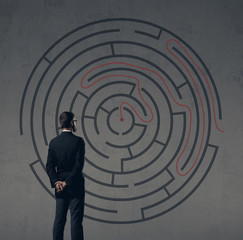 Businessman standing over labyrinth background. Business, strategy, concept.