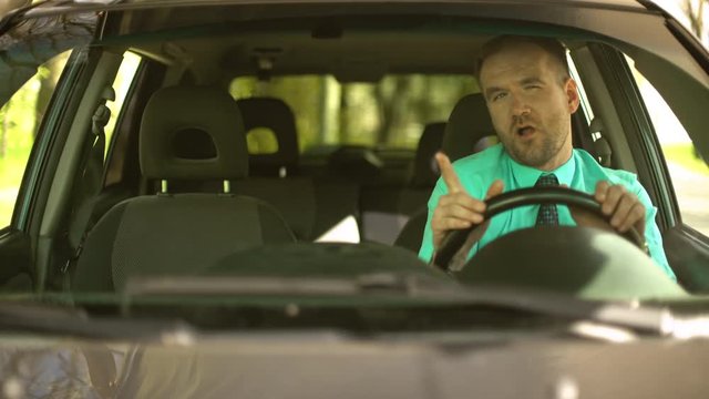 Bussinesman Sitting In Car Wearing Green Shirt And Tie Dancing And Singing