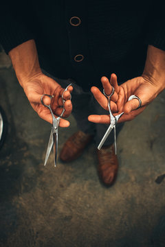 Hair Stylist Holding Pair of Scissors In Hands