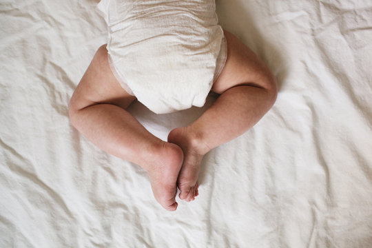 backside of a baby laying on a blanket
