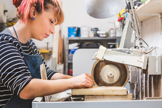 Artisan Woman Cutting Stone with a Circular Saw for Mosaic Artwo