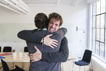 Happy business people celebrating success in the office