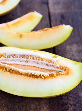 Sliced melon on a brown wooden table
