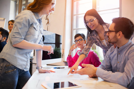 Young group of architects discussing business plans
