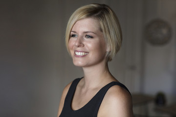 Close Up Of A Pretty Blond Woman Smiling And Looking Away.