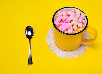 Yellow cup with multi-colored marshmallow
