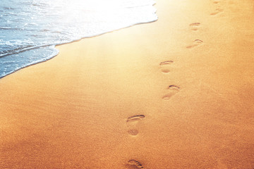 Fußspuren im Sand am Strand - obrazy, fototapety, plakaty