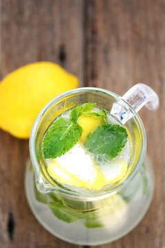 top view of Jar with fresh mint lemonade on wooden table