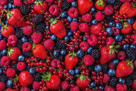 Fototapeta Forest fruit overhead berries assorted mix in studio on dark background in studio. Raspberry, blueberry, red currant