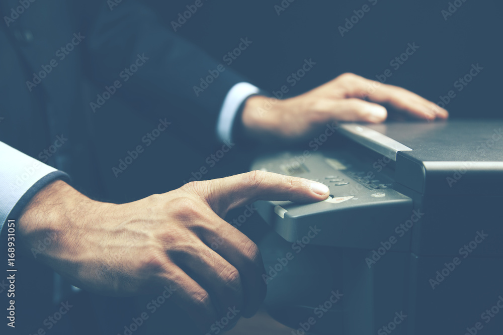 Poster man scan a document by the printer in the office