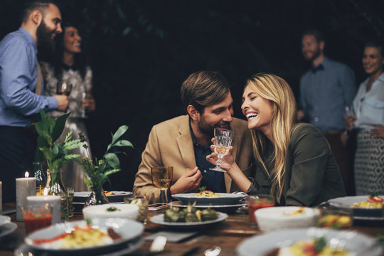 Couple Having Fun At The Dinner Party
