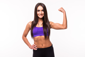 Cheerfully smiling mixed race sporty woman demonstrating biceps, isolated on white background