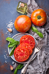 Sliced tomato on blue rusty background