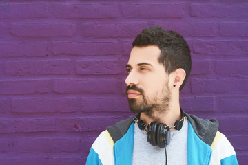 Latin man listening music with headphones.