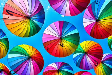 Rainbow umbrella on sky background. Many colorful umbrellas. umbrella street decoration