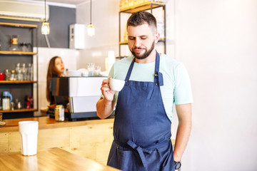 A barista man tries coffee