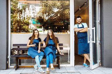 A team of young barists near a cafe