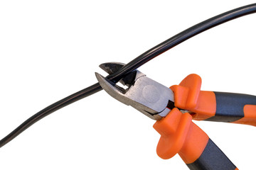 Cutting black wire by nippers, trimming the cable, isolated on white background