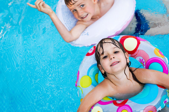 Picture Of Little Kids Enjoying In Swimming Pool