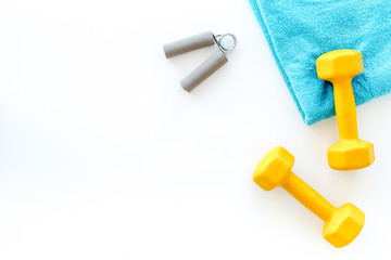 Equipment for fitness. Dumbbells and expander on white background top view copyspace