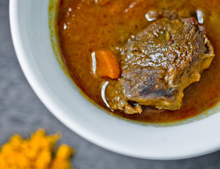 cup of steaming hot soup with spices