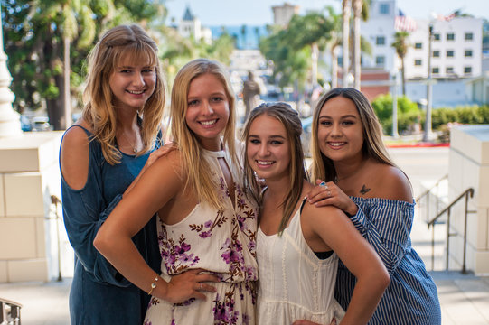Pretty college girls together in a group posed over the downtown Ventura streets.