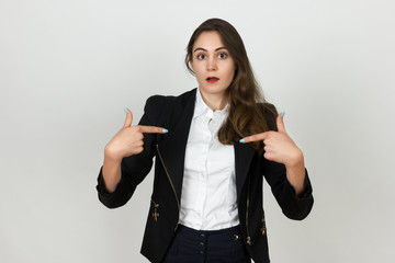 Beautiful smiling young businesswoman  shows a finger on the 
