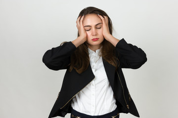 Portrait of a pretty young businesswoman stress and headache having migraine pain