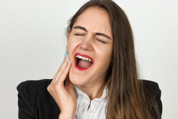 Portrait of a pretty young businesswoman having toothache. Pain concept close-up