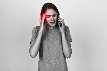 Portrait of a pretty woman  stress and headache having migraine pain. Black and white with red...
