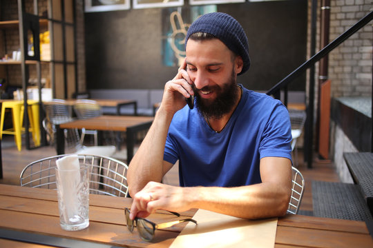 Bearded man talking on phone