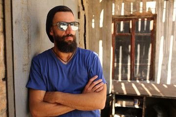 Man in sunglasses with crossed arms. Close up