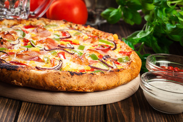 Homemade pizza with bacon, paprika and corn