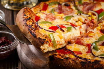 Homemade pizza with bacon, paprika and corn