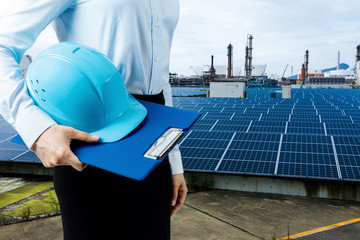 engineer holding helmet and solar power plant. renewable energy concept. © metamorworks