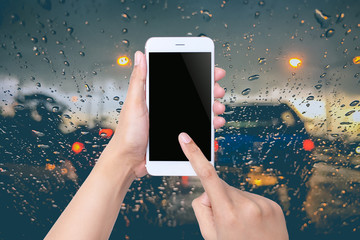 Woman using smartphone on blurred abstract city traffic backgroud
