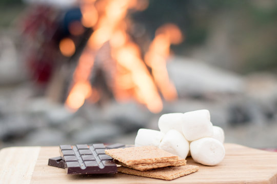 Smores Ingredients at a Beach Bonfire with Chocolate, Marshmellow, and Graham Crackers with Room for Copy