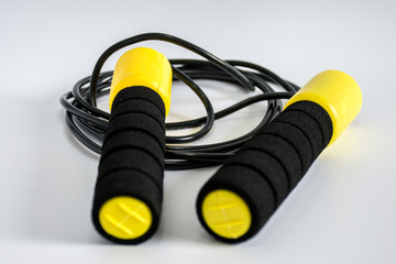 yellow jump rope on white ground