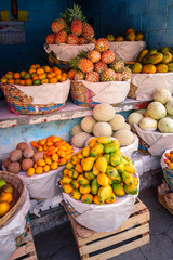 Tropical colorful fruit stand on the road in the remote village San Juan La Laguna in the highlands...