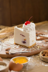 cheese cream cake topping with whipped cream and cherry. cake background concept