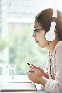 Asian woman listening to the music.