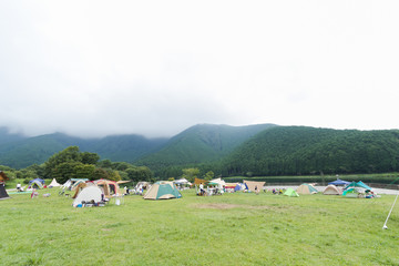 Fototapeta na wymiar Lake and mountain view ,Camping tents in Yamanashi Prefecture, Japan .