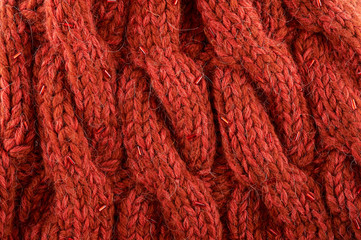 Red wool knitted texture background. Top view.