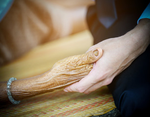 young hand hold hands of eldery woman. Senior help concept.
